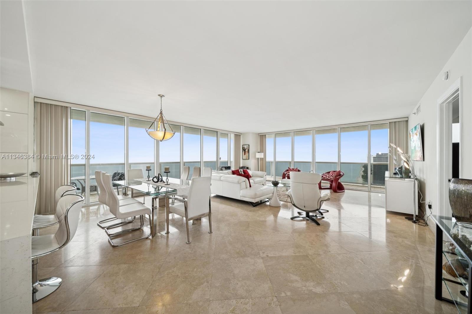 A bright, open-concept living and dining area features floor-to-ceiling windows with ocean views — 1830 S Ocean Dr # 4602, Hallandale Beach FL 33009, HALLANDALE BEACH, FL