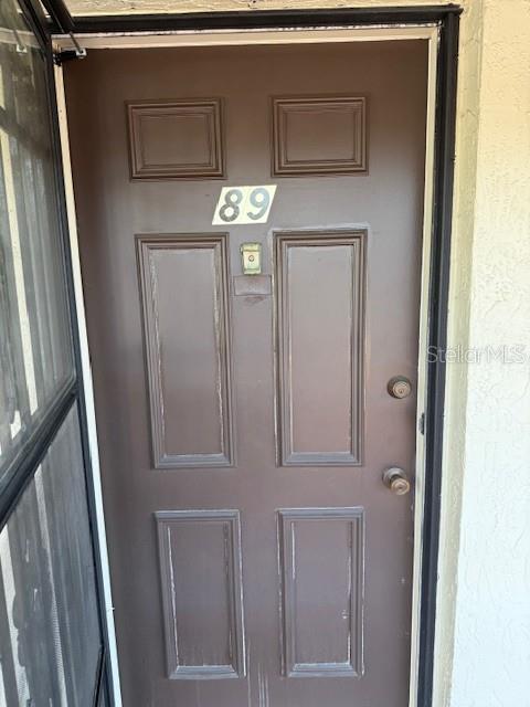A brown front door with the number 89 and a screen door frame — 1100 EAST BAY DRIVE UNIT 89, LARGO, FL