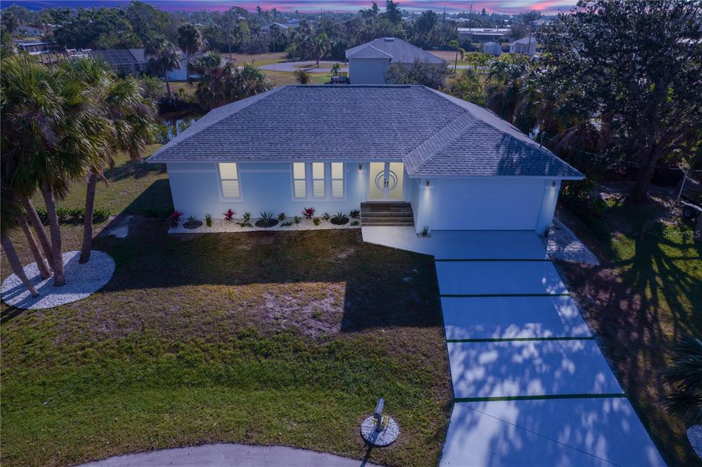 An aerial view of a light blue single-story house with a gray roof and driveway — 3004 BANYAN WAY, PUNTA GORDA, FL