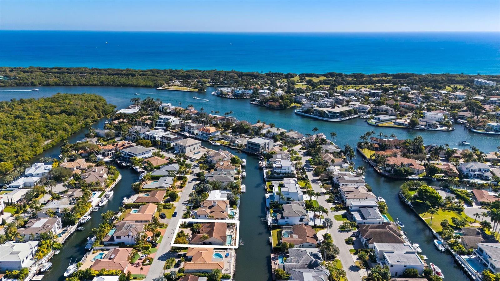 An aerial view shows a waterfront residential neighborhood with a highlighted house and pool — 520 Phillips Drive, Boca Raton FL 33432, BOCA RATON, FL