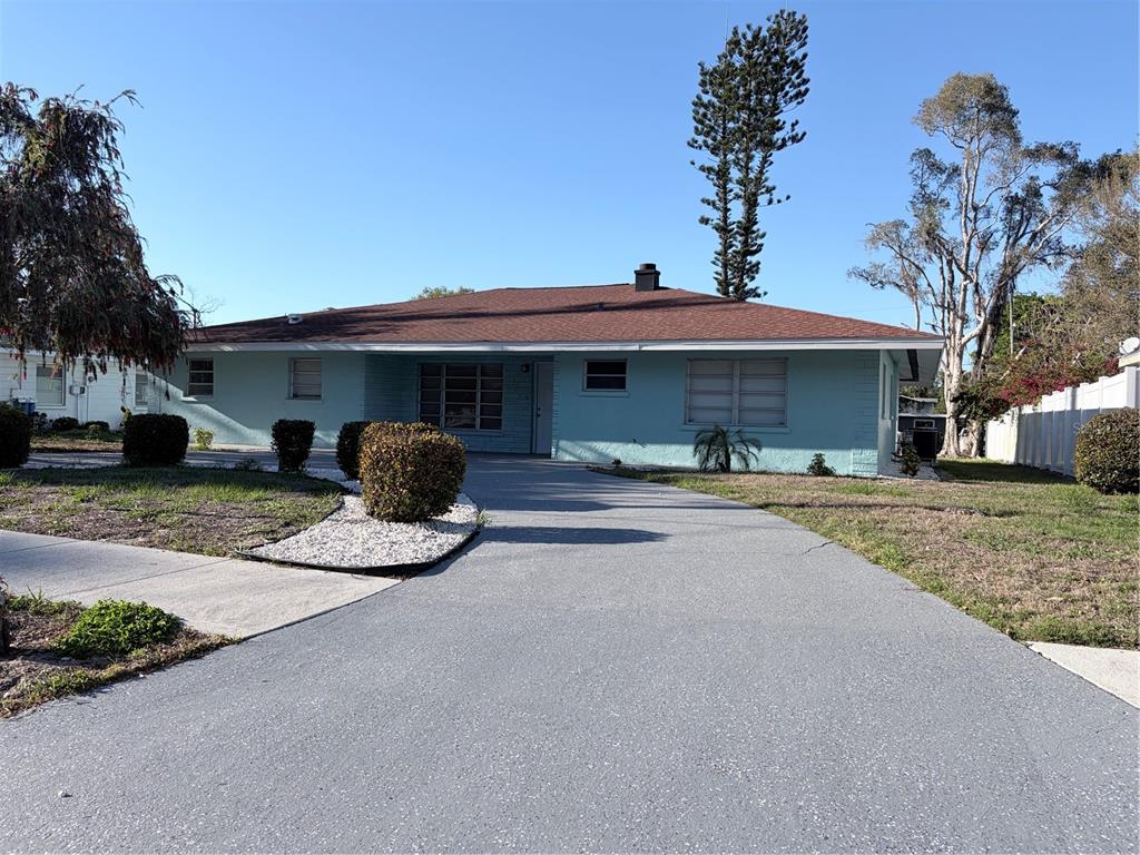 A light blue, single-story house with a brown roof and a paved driveway — 1339 22ND STREET, SARASOTA, FL