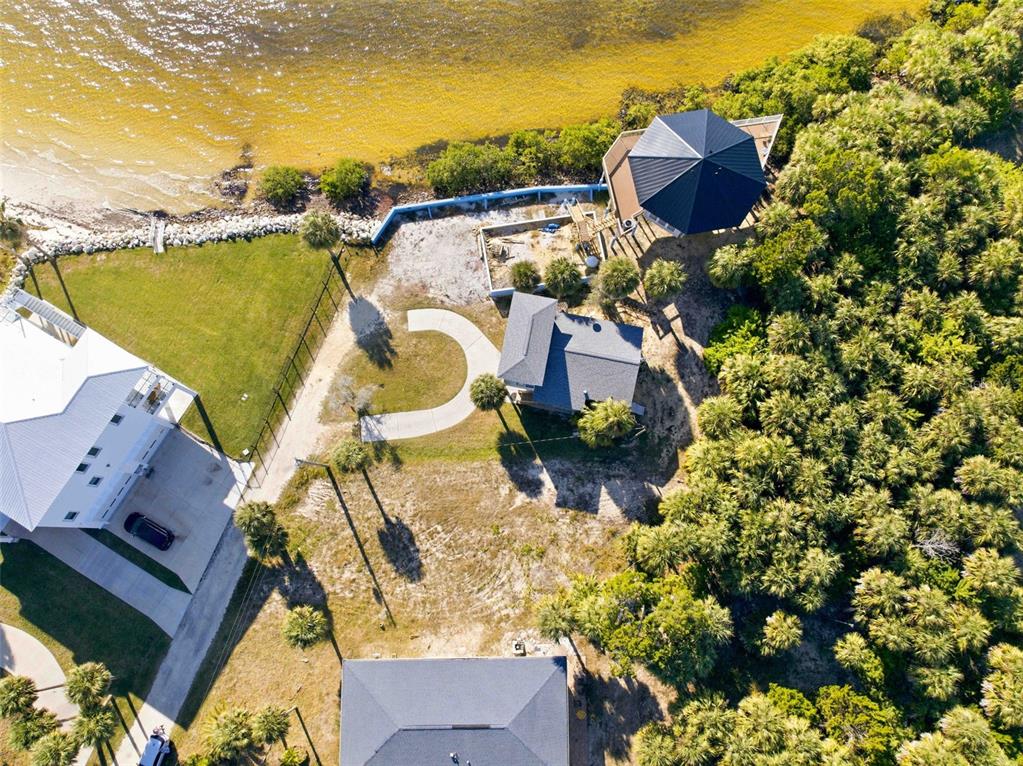 An aerial view shows several houses, a curved driveway, and a gazebo near the water — 3461 CYCLONE DRIVE, WEEKI WACHEE, FL