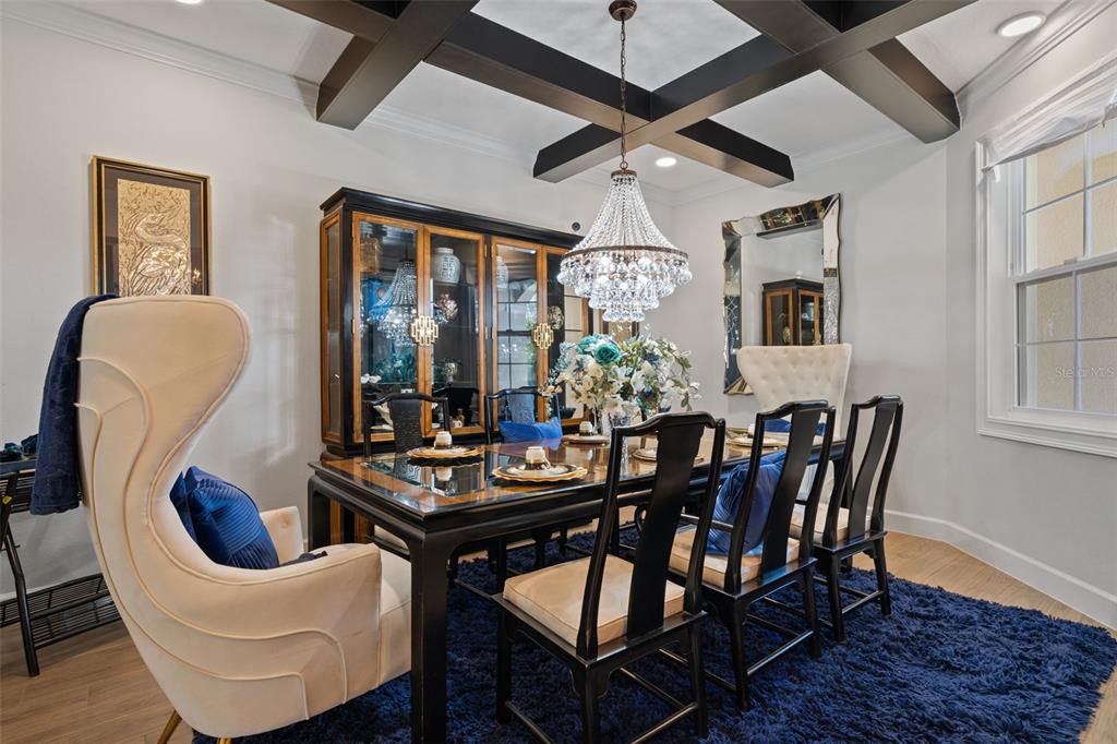 A dining room features a coffered ceiling, a crystal chandelier, and a dark wood table — 2534 CEDAR SHAKE COURT, OVIEDO, FL