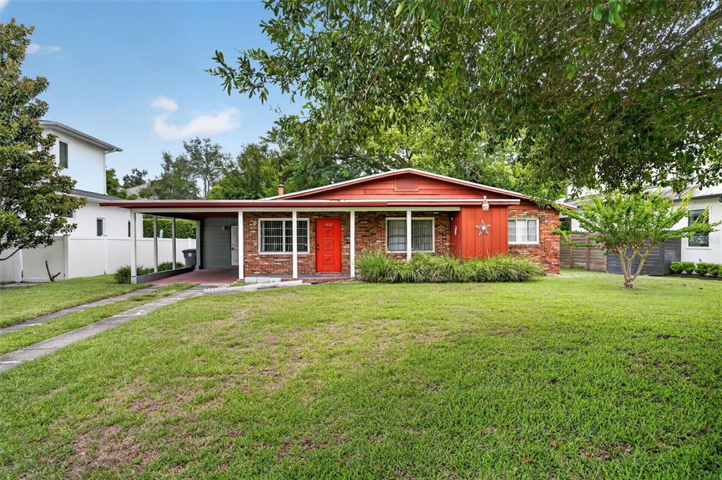 A single-story brick house with a red front door and an attached carport — 1622 ARBOR PARK DRIVE, WINTER PARK, FL