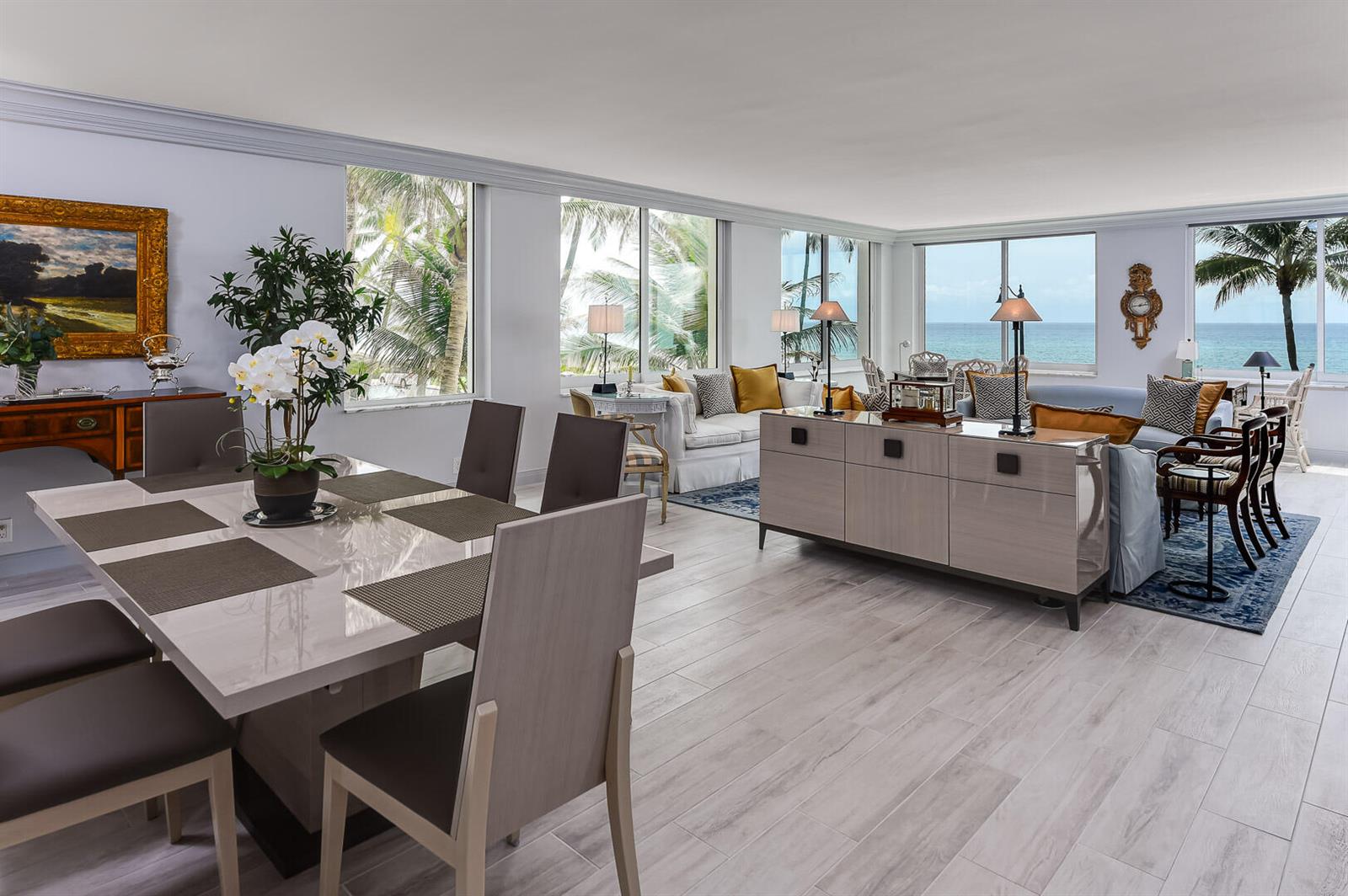 An open-concept living and dining area features light wood floors and expansive ocean-view windows — 340 S Ocean Boulevard # 2b, Palm Beach FL 33480, PALM BEACH, FL