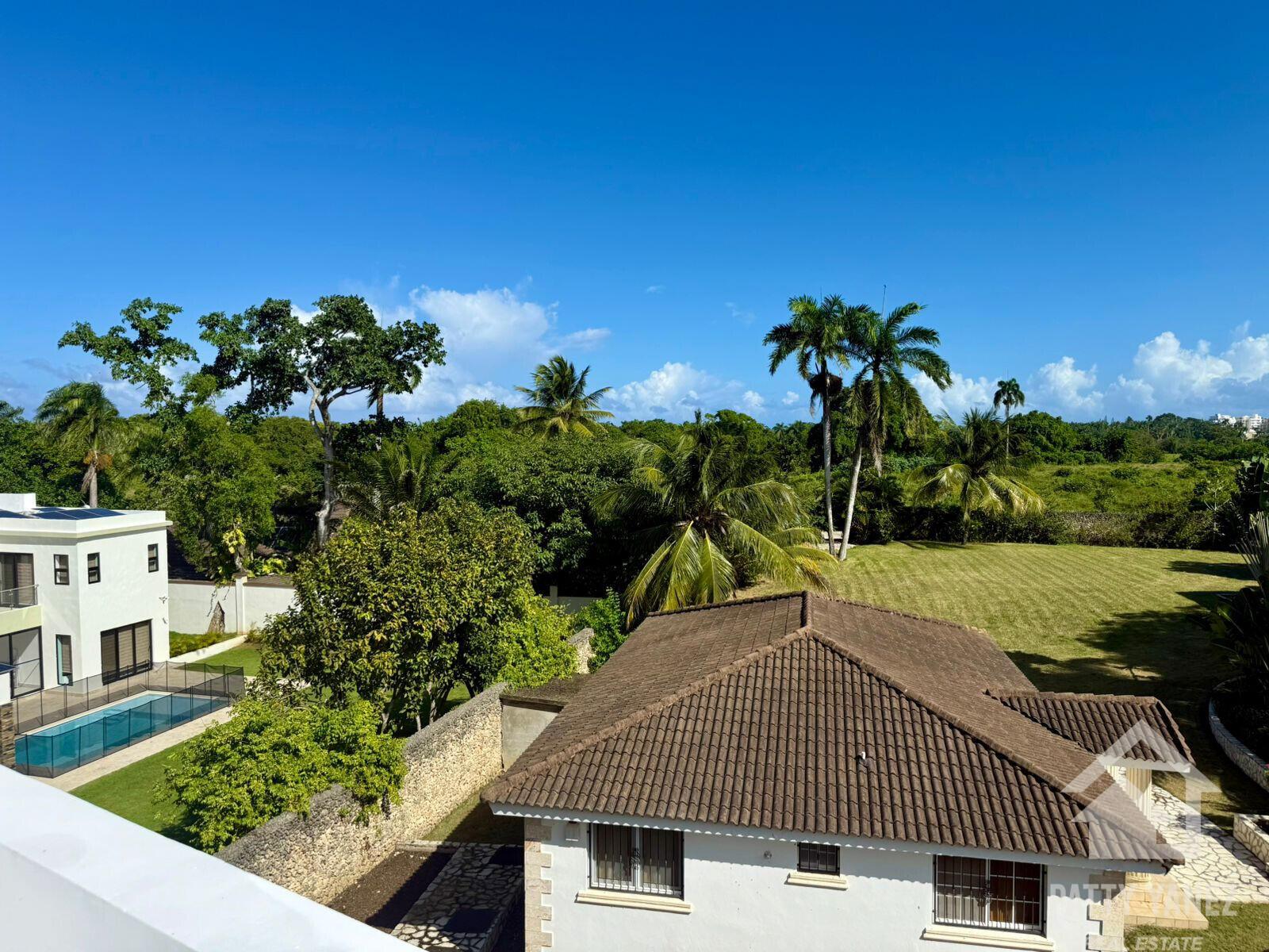 An elevated view shows a white house with a tiled roof, a pool, and palm trees — Perla Marina Residential Calle Perla, FL