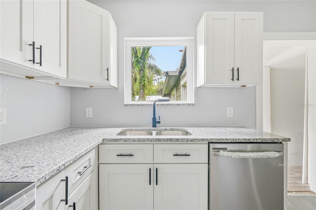 An empty room with light blue walls, gray wood-look flooring, and a ceiling fan — 8500 N BOULEVARD, TAMPA, FL