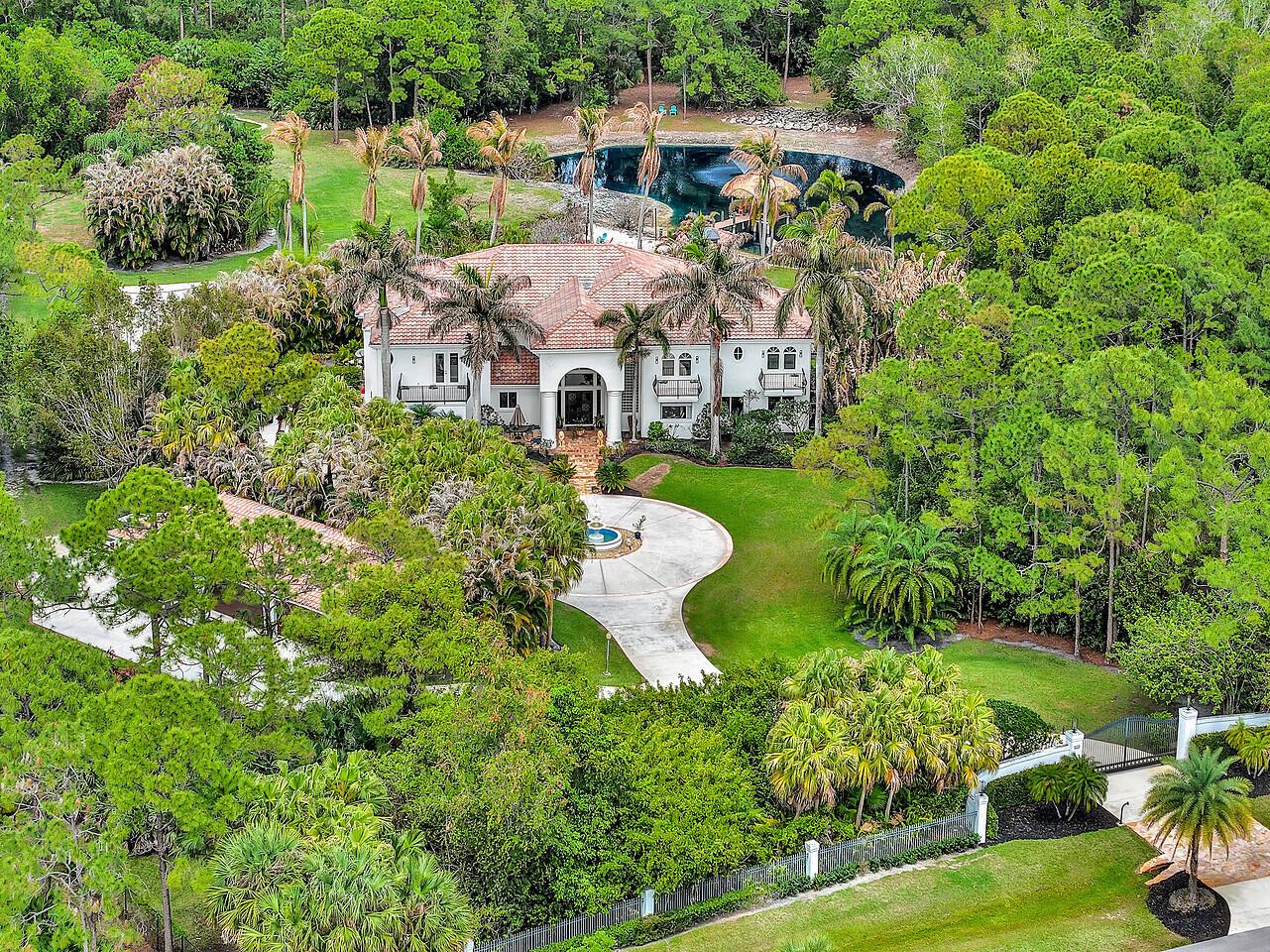 An aerial view of a large white house with a tile roof and circular driveway — 2584 SE Ranch Acres Circle, Jupiter FL 33478, JUPITER, FL