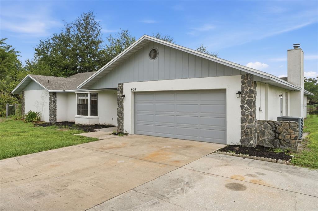 This home office features a desk, a bookshelf, floating shelves, and a window — 408 COLEMAN DRIVE, WINTER HAVEN, FL