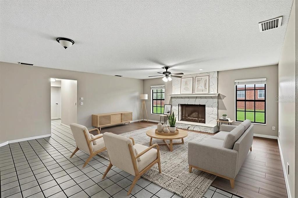 A virtually staged bedroom features a twin bed, a small table with chairs, and shelving — 408 COLEMAN DRIVE, WINTER HAVEN, FL