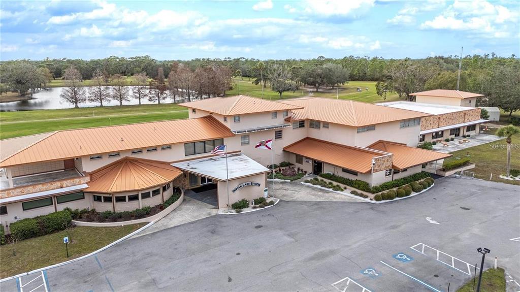 An aerial view shows a large, multi-level commercial building with a metal roof and parking — 0 OLEANDER DRIVE, INDIAN LAKE ESTATES, FL