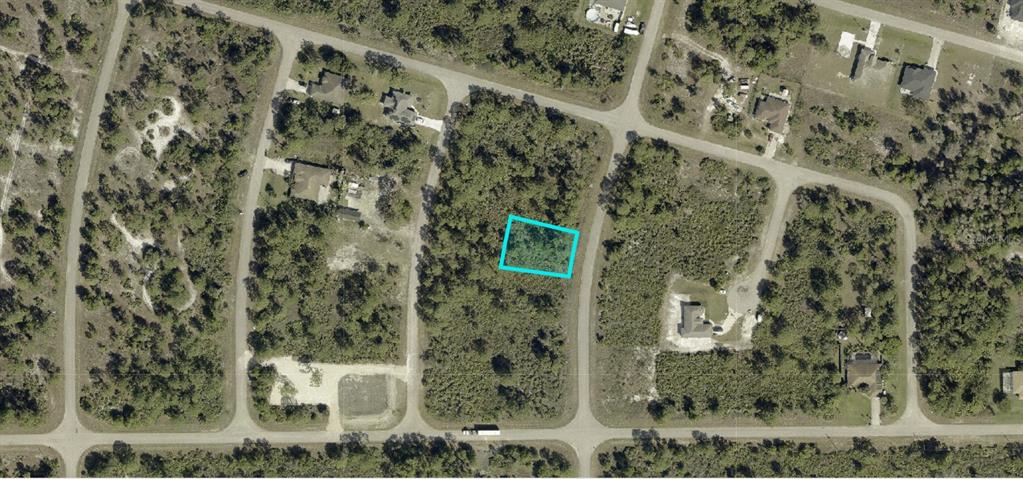 This is an aerial map view of a vacant, wooded residential lot outlined in blue — 1254 BURLWOOD AVENUE, FORT MYERS, FL