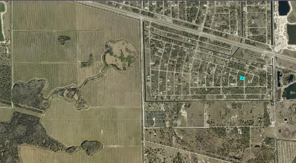 An aerial map view shows a residential neighborhood adjacent to large agricultural fields and wetlands — 1254 BURLWOOD AVENUE, FORT MYERS, FL