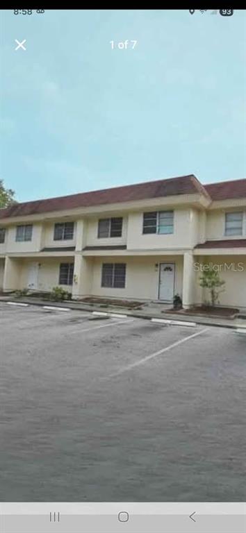 A two-story apartment building with a parking lot in the foreground — 3715 COLBY STREET, SARASOTA, FL