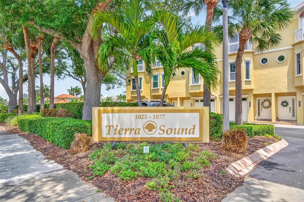 A sign for Tierra Sound stands in front of a yellow multi-story residential building — 1033 PINELLAS BAYWAY  S, TIERRA VERDE, FL
