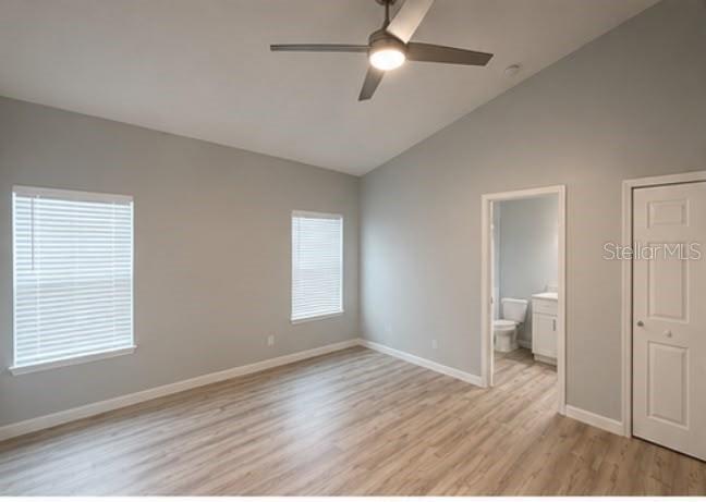 An empty bedroom features light gray walls, wood-look flooring, two windows, and a ceiling fan — 617 HOLMES AVENUE, DAYTONA BEACH, FL