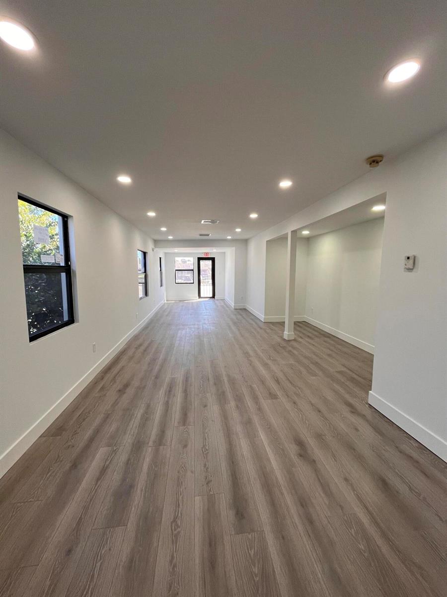 A long, narrow room features light wood-look flooring, white walls, and recessed ceiling lighting — 900 Federal Highway, Riviera Beach FL 33403, RIVIERA BEACH, FL
