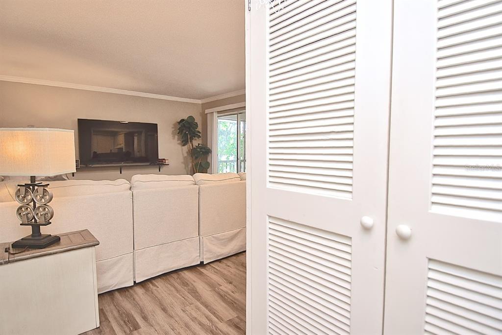 A view from a doorway looking into a living room with a white sectional sofa — 2121 WOOD STREET UNIT 201, SARASOTA, FL