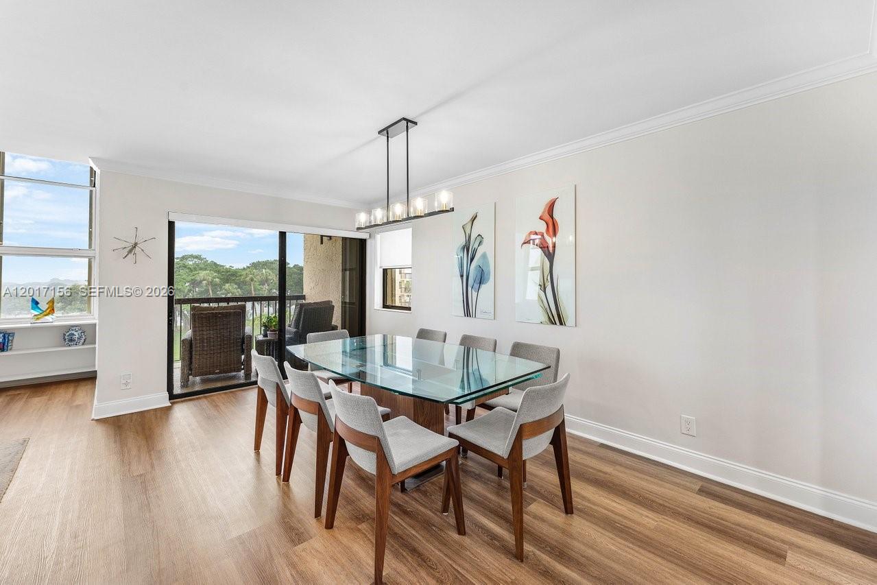 A dining room features a glass-topped table, six gray chairs, and a balcony view — 364 Golfview Rd # 505, North Palm Beach FL 33408, NORTH PALM BEACH, FL