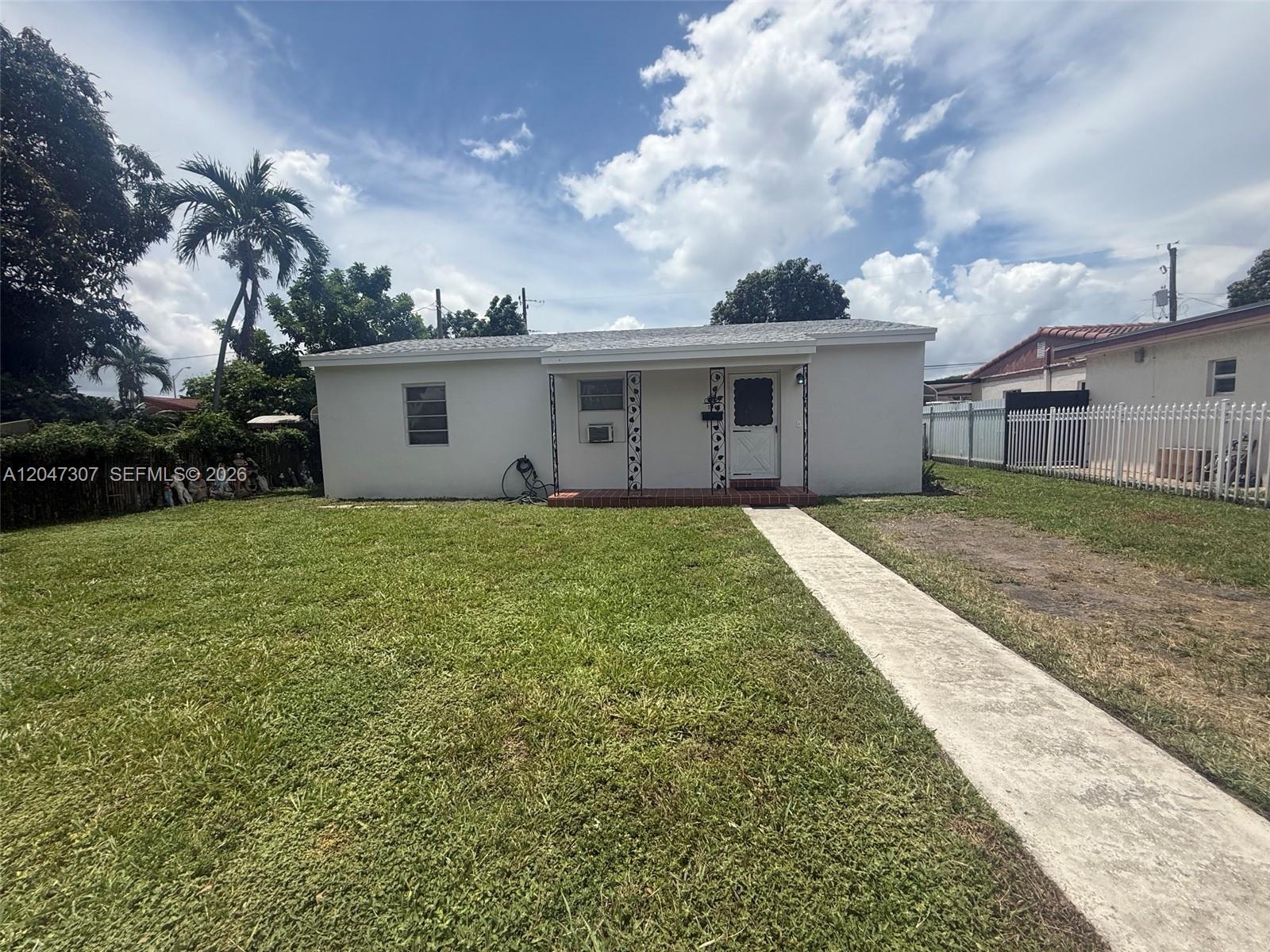 A white single-story house with a front lawn and a concrete walkway — 790 E 6th Pl, Hialeah FL 33010, HIALEAH, FL