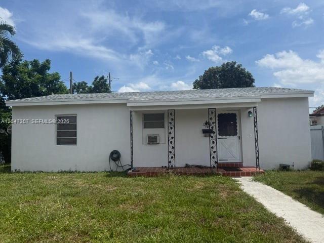 A single-story white house features a front porch with decorative metal columns and tile flooring — 790 E 6th Pl, Hialeah FL 33010, HIALEAH, FL