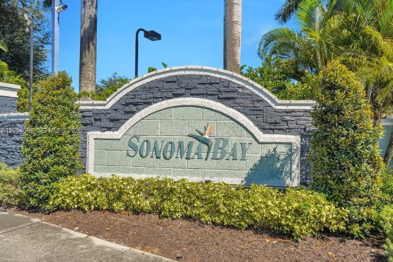 A stone-accented monument sign for Sonoma Bay stands outdoors surrounded by landscaping and palm trees — 1942 Alamanda Way, Riviera Beach FL 33404, RIVIERA BEACH, FL