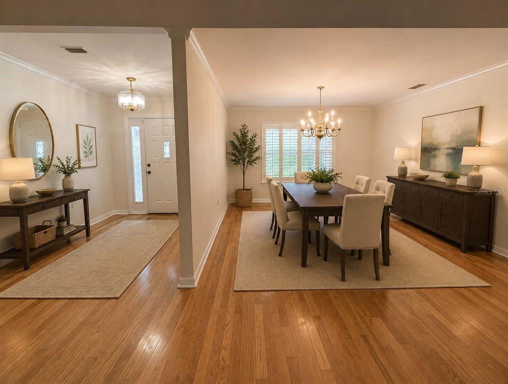 A dining room and entryway feature hardwood floors, area rugs, and traditional furniture — 6124 SW 35TH WAY, GAINESVILLE, FL