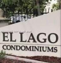A beige sign with black lettering reads El Lago Condominiums in front of a fence — 5501 NW 7th St # E408, Miami FL 33126, MIAMI, FL
