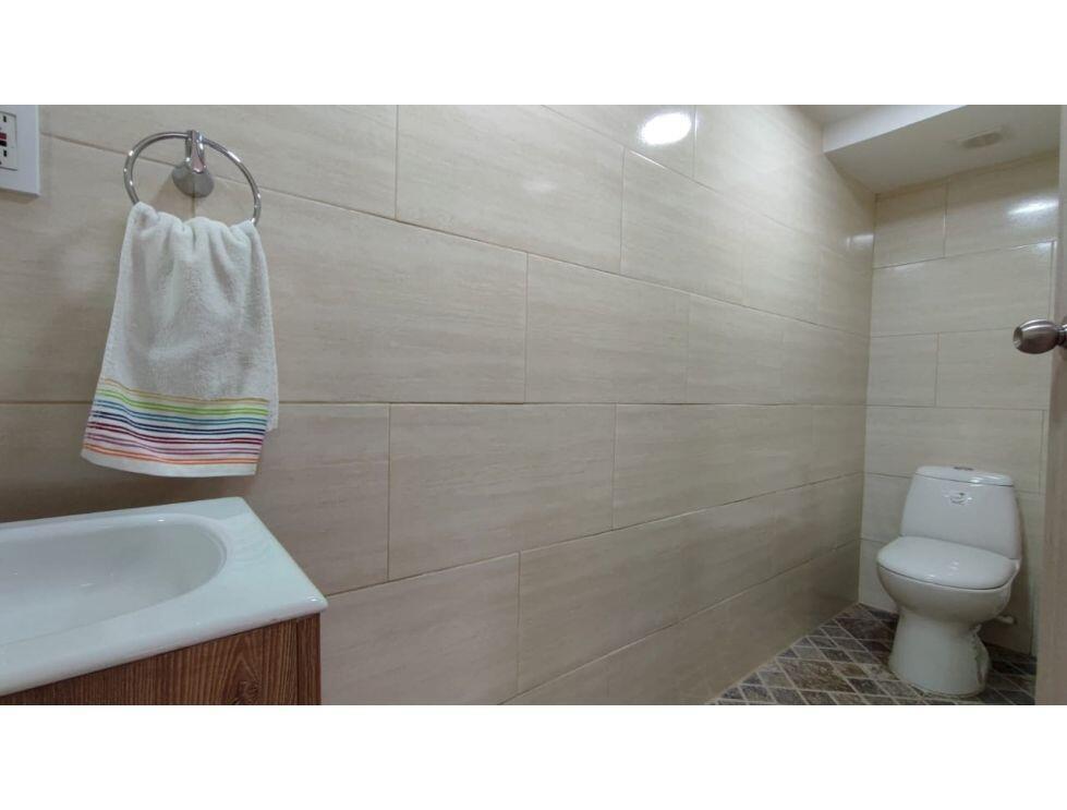 A bathroom features beige wall tiles, a white sink, a towel ring, and a toilet — 8-77 Carrera 8va. Barrio Chipre # 77, FL