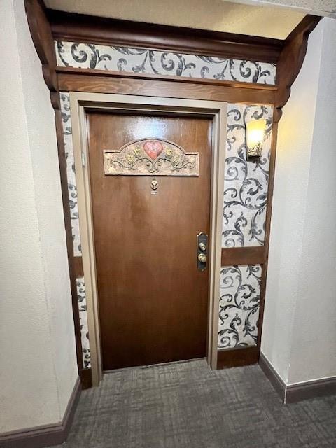 A wooden door with a heart-shaped plaque is framed by decorative wallpaper and wood trim — 3740 Inverrary Drive # 2u, Lauderhill FL 33319, LAUDERHILL, FL
