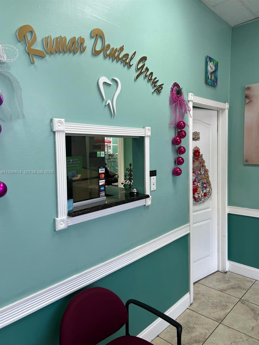 A dental office reception area features a service window, teal walls, and signage — 4750 NW 7 ST, Miami FL 33126, MIAMI, FL