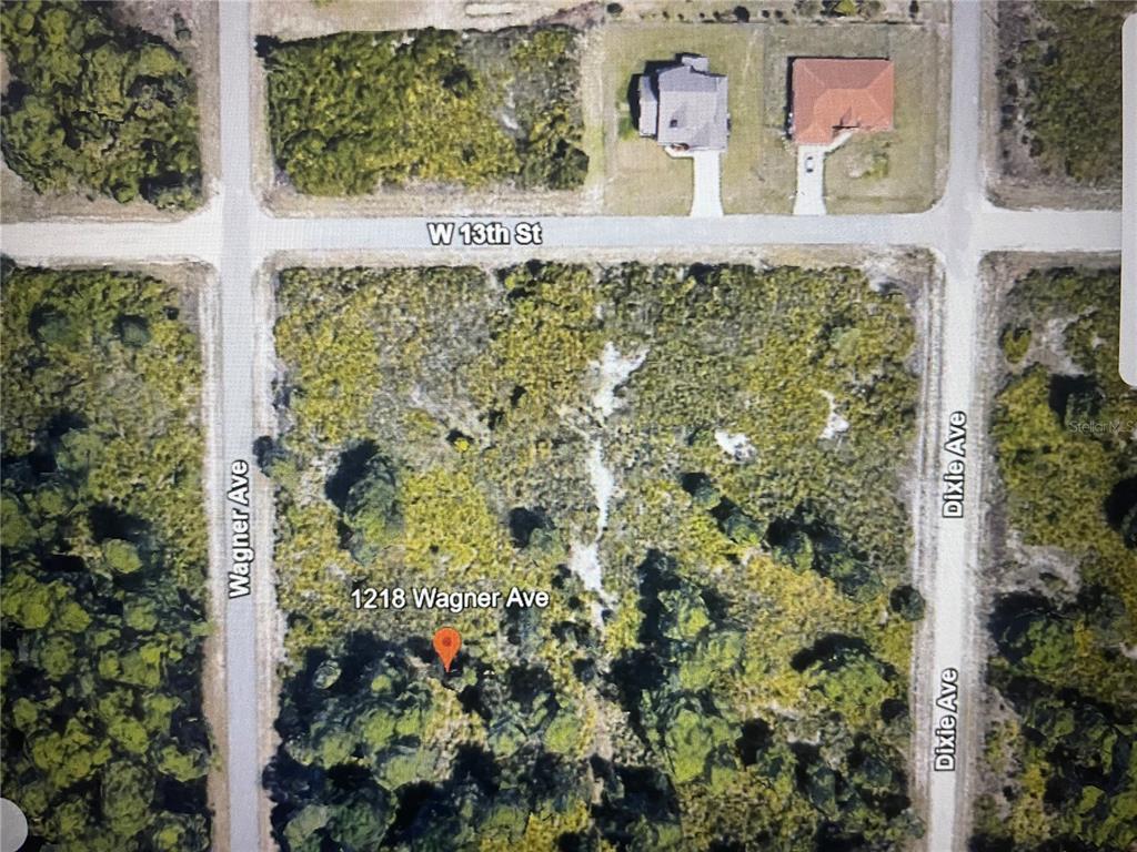 This is an aerial map view of a vacant, wooded corner lot — 1218 WAGNER AVENUE, LEHIGH ACRES, FL