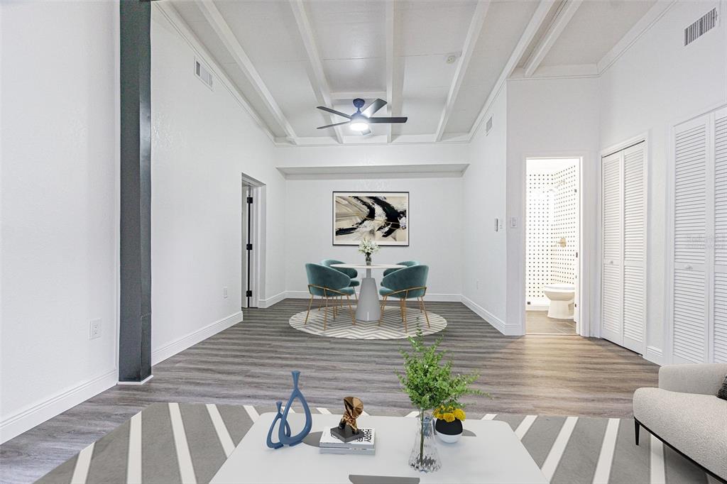 A dining area with a round table and two teal chairs under a ceiling fan — 416 COUNTRY CLUB DRIVE, OLDSMAR, FL