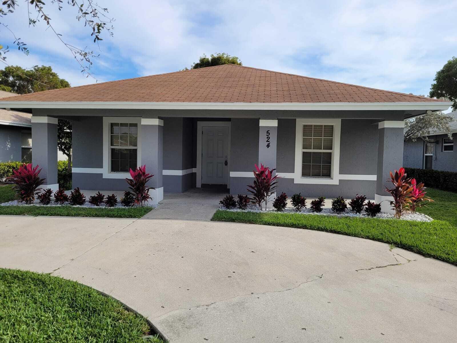 A gray single-story house with a brown roof, white trim, and a concrete driveway — 524 Southridge Road, Delray Beach FL 33444, DELRAY BEACH, FL