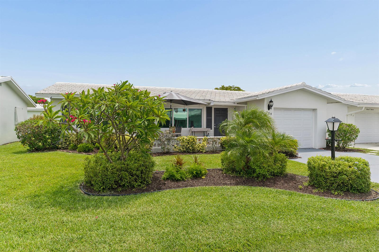 A single-story white house with a garage and a landscaped front yard — 709 SW 15th Street, Boynton Beach FL 33426, BOYNTON BEACH, FL