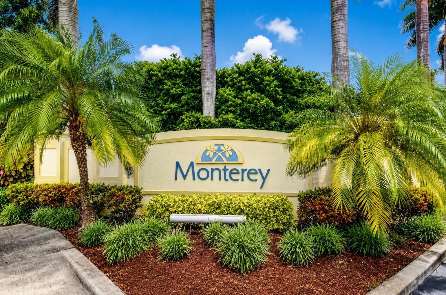 A beige community entrance sign for Monterey is surrounded by palm trees and landscaping — 340 Lake Monterey Circle, Boynton Beach FL 33426, BOYNTON BEACH, FL