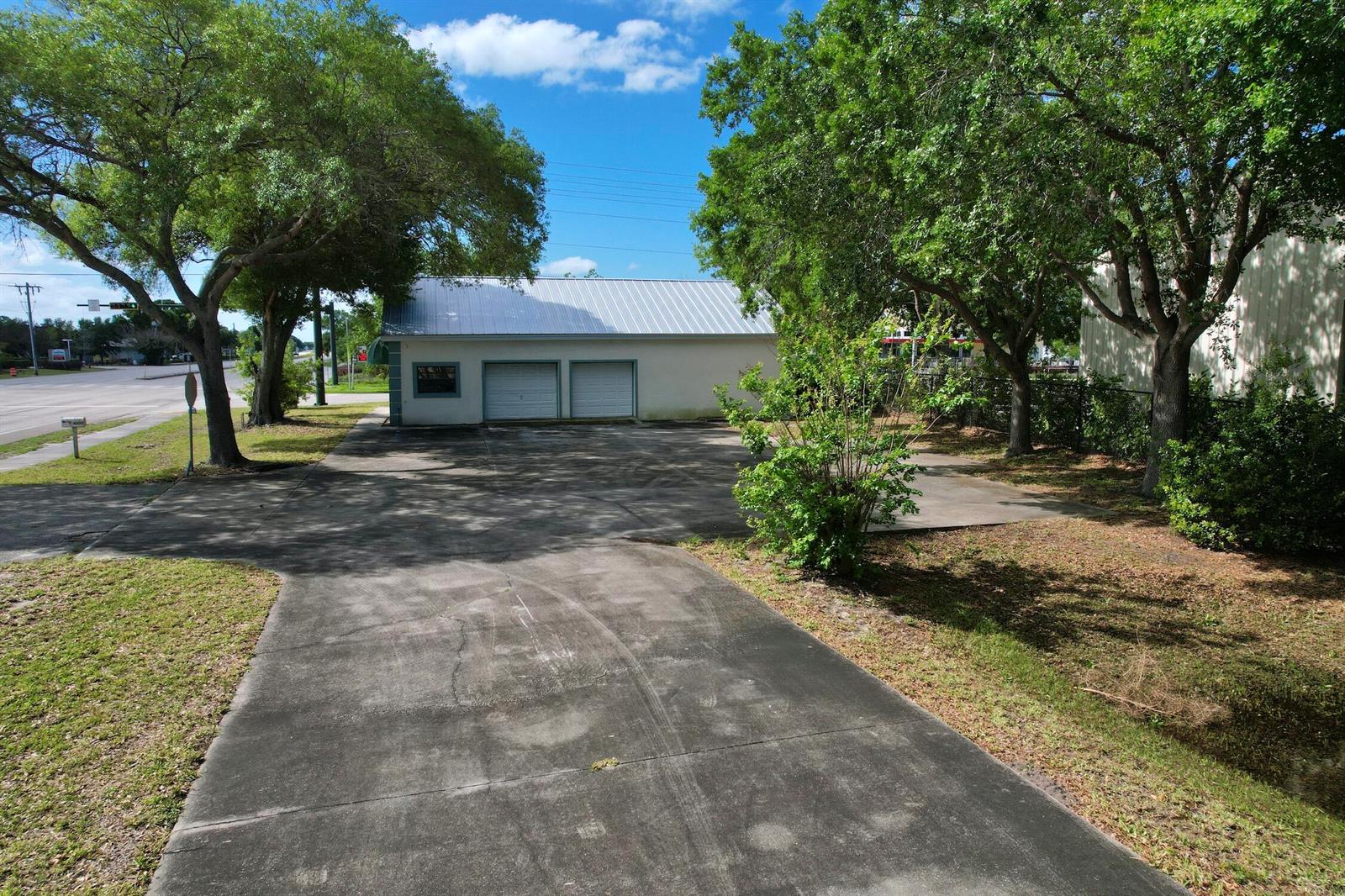 A detached garage with a metal roof sits at the end of a concrete driveway — 4505 Us Highway 1 Highway, Vero Beach FL 32967, VERO BEACH, FL