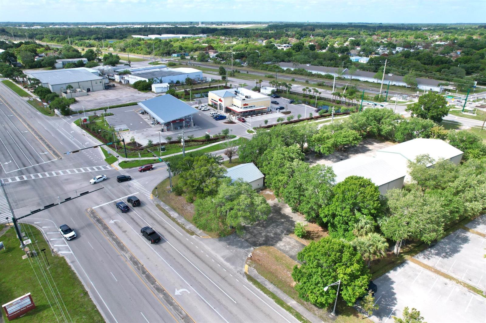 An aerial view shows a commercial intersection with a gas station, retail building, and parking — 4505 Us Highway 1 Highway, Vero Beach FL 32967, VERO BEACH, FL