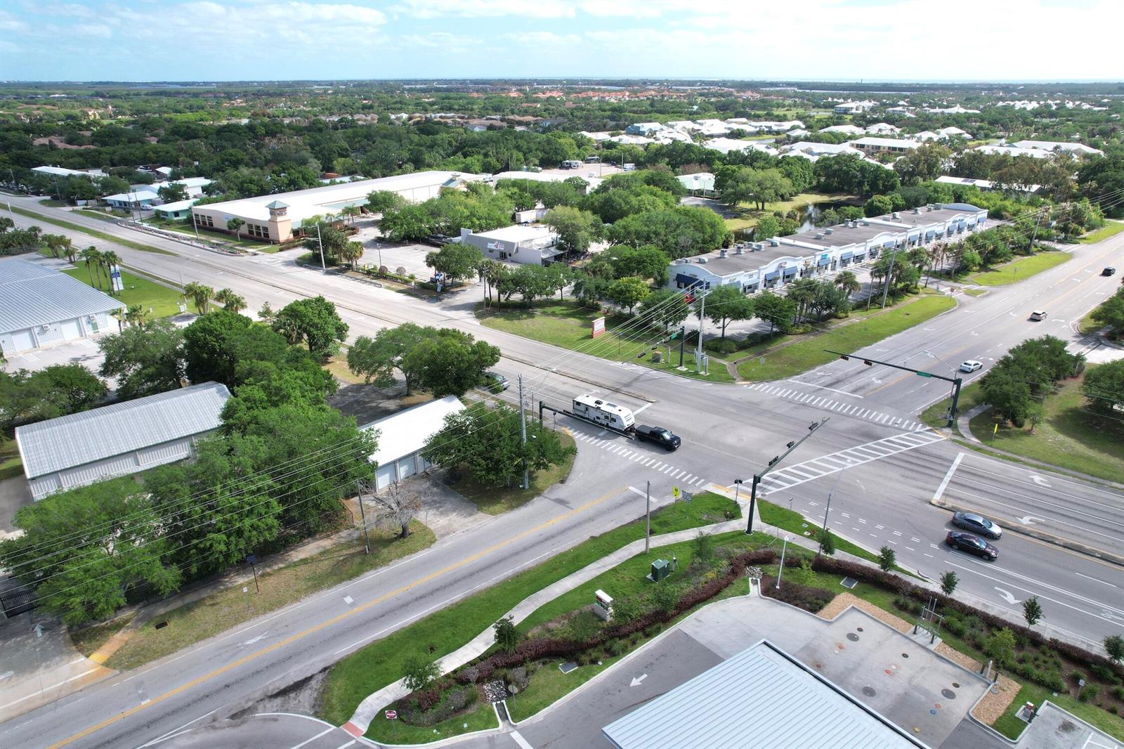 An aerial view shows a commercial intersection with surrounding businesses, parking lots, and green space — 4505 Us Highway 1 Highway, Vero Beach FL 32967, VERO BEACH, FL