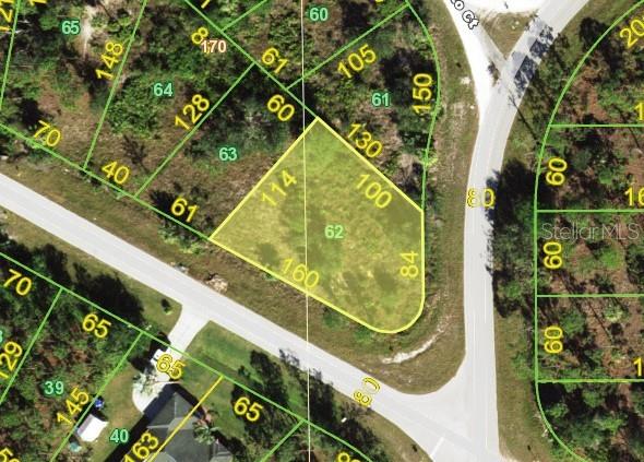 This is an aerial map showing a vacant, triangular-shaped residential lot highlighted in yellow — 27554 MONTE CRISTO BOULEVARD, PUNTA GORDA, FL
