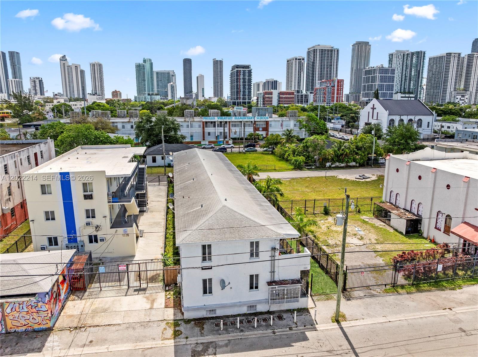 An aerial view shows two multi-story apartment buildings separated by a narrow driveway — 1829 NW 2nd Ct, Miami FL 33136, MIAMI, FL