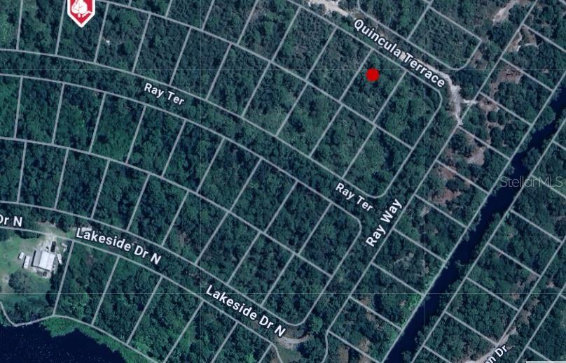 This is an aerial map showing a vacant lot marked with a red dot — 1013 W VENETIAN DRIVE, SEBRING, FL