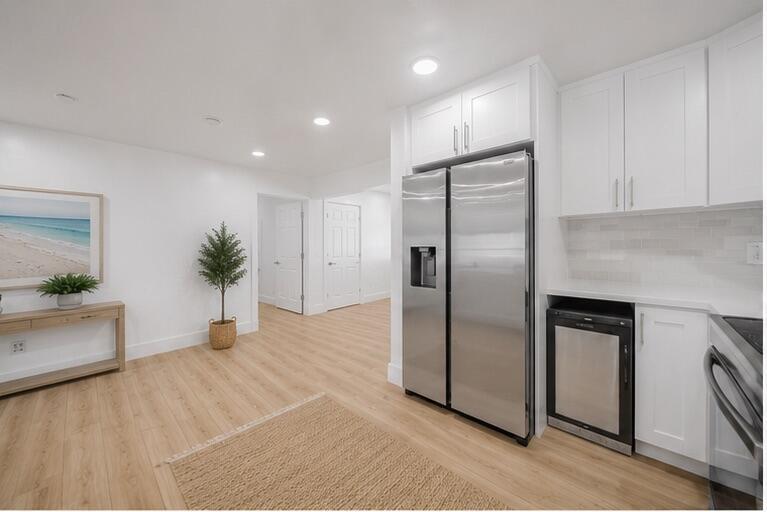 A kitchen with white cabinets, stainless steel appliances, and light wood flooring — 2106 Alfred Drive, Boynton Beach FL 33426, BOYNTON BEACH, FL