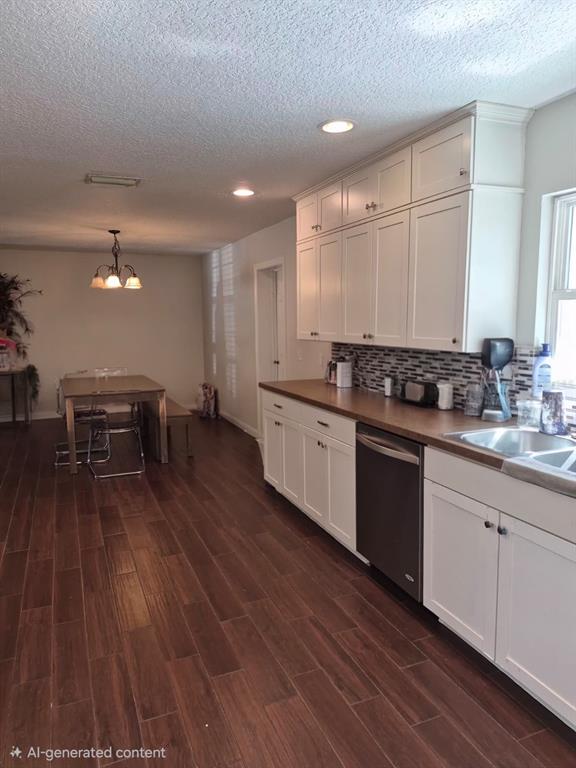 This kitchen features white cabinets, a wood-look countertop, and dark wood-plank flooring — 2729 HARRIET DRIVE, ORLANDO, FL