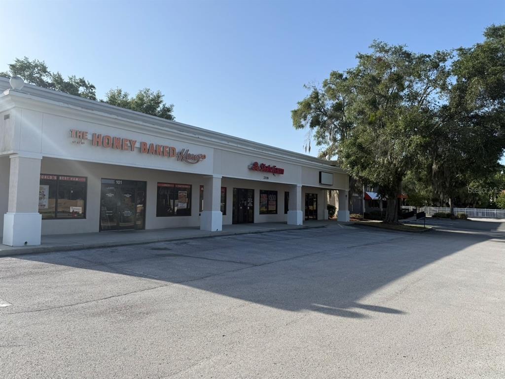 A commercial strip mall building features a Honey Baked Ham store and a State Farm office — 2709 SW 27TH AVENUE UNIT 103, OCALA, FL