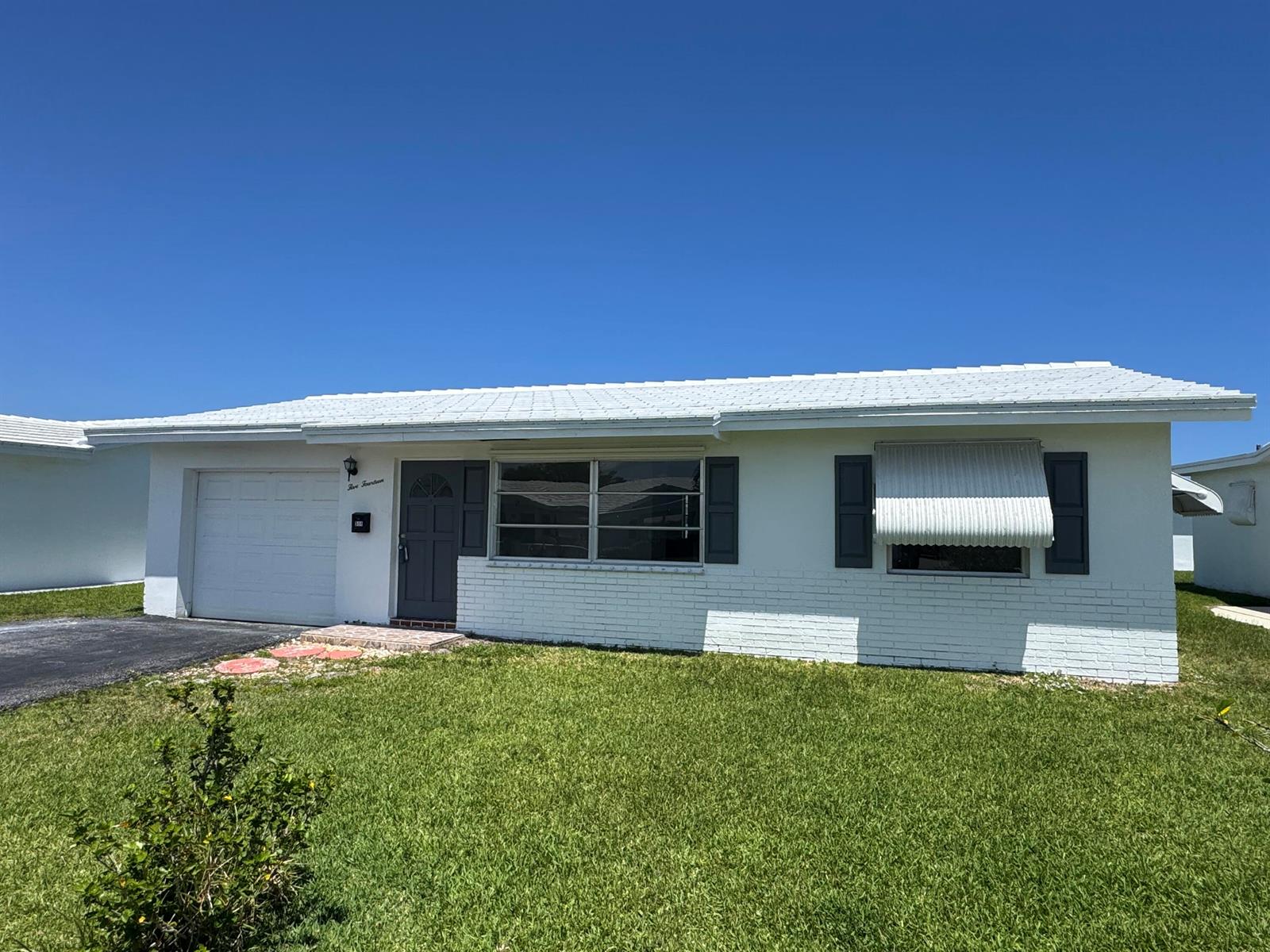 A white single-story house with a garage, brick facade, and dark gray shutters — 514 SW 20th Street, Boynton Beach FL 33426, BOYNTON BEACH, FL