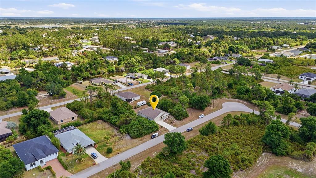 An aerial view shows a single-story house with a yellow location pin on a street — 126 GREEN PINE PARK, ROTONDA WEST, FL
