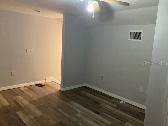 An empty room features light gray walls, wood-look flooring, and a ceiling fan — 5527 GAUR LANE, LAKELAND, FL