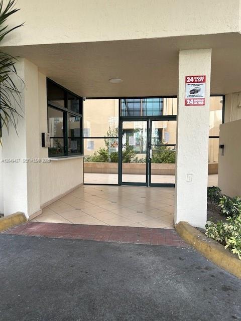 A covered entrance leads to a glass-paned doorway and a security window — 2055 SW 122nd Ave # 101, Miami FL 33175, MIAMI, FL