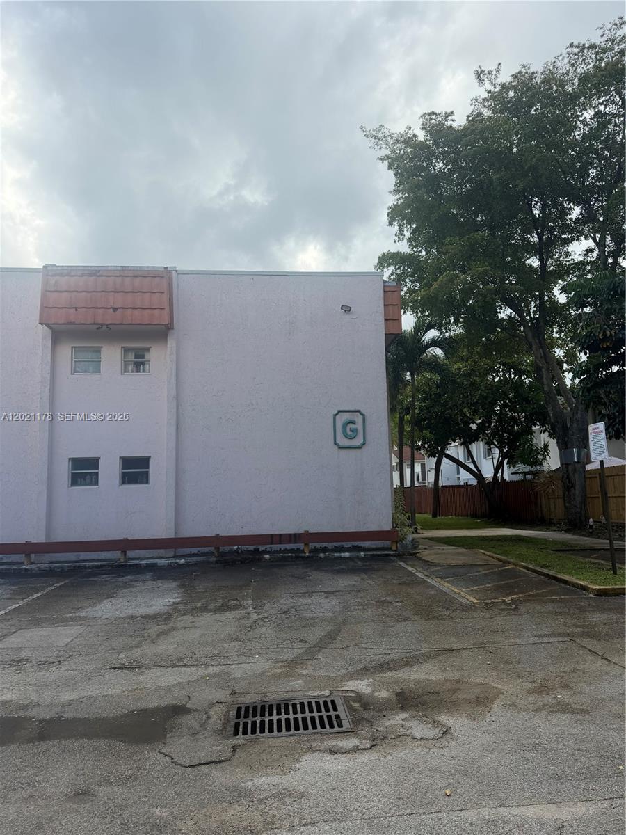 The exterior of a light-colored multi-story apartment building features a large letter G sign — 7610 Stirling Rd # 205G, Davie FL 33024, DAVIE, FL